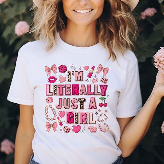 Trendy coquette graphic featuring the phrase "I'm Literally Just a Girl" surrounded by pink bows, lipstick, hearts, cherries, pearls, dice, and feminine icons. Perfect for aesthetic graphic tees, hoodies, and girly fashion.
