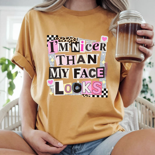 Funny graphic featuring the phrase "I'm Nicer Than My Face Looks" in a trendy ransom note collage with leopard print, checkerboard accents, glitter details, and pink aesthetic elements. Perfect for sarcastic graphic tees and hoodies.
