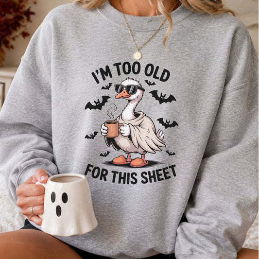 I'm Too Old For This Sheet Halloween DTF transfer featuring a funny goose in sunglasses and slippers holding a coffee mug with flying bats and spooky details