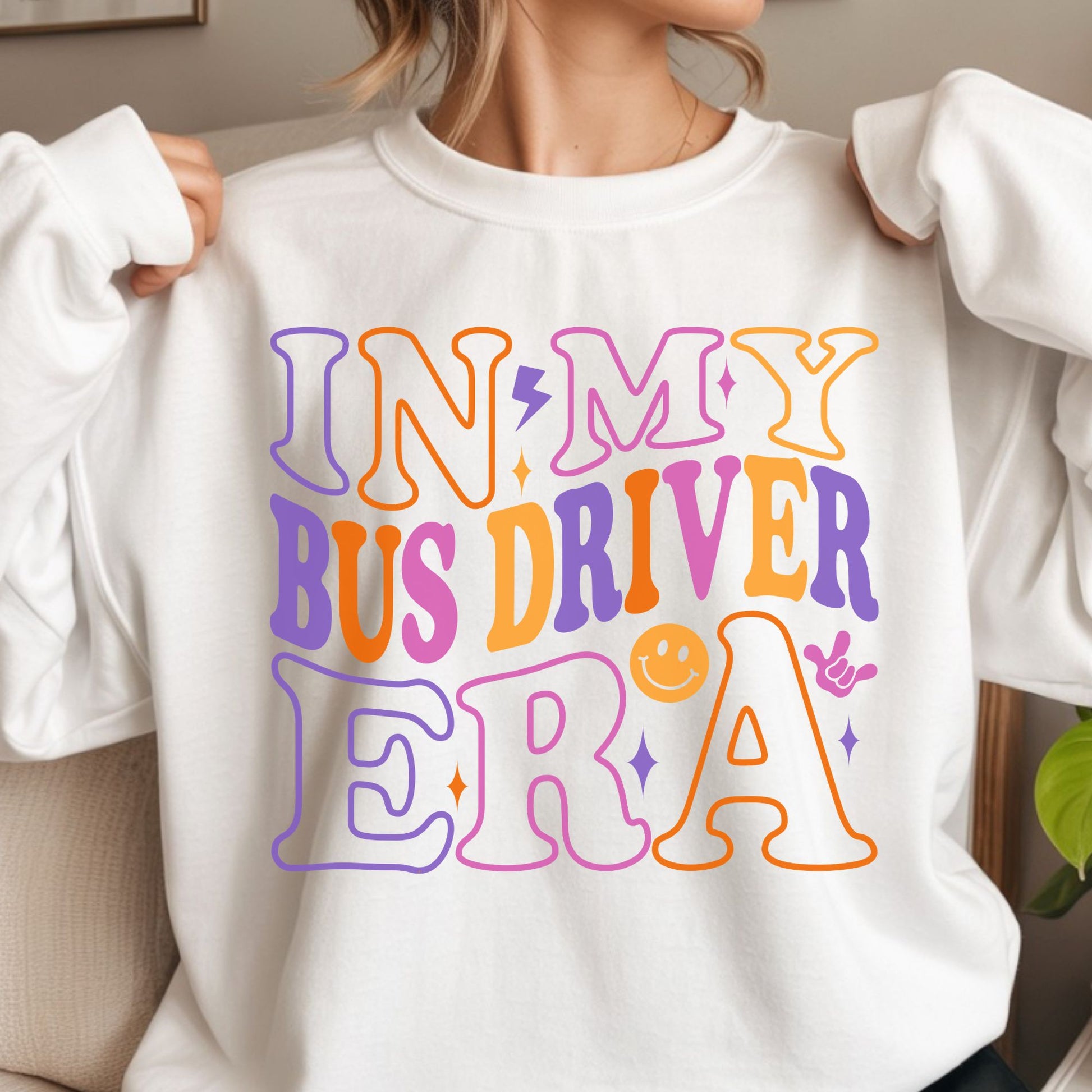 In My Bus Driver Era design featuring oversized retro lettering in purple, orange, pink, and yellow with a lightning bolt, smiley face, sparkles, and playful school transportation staff style.