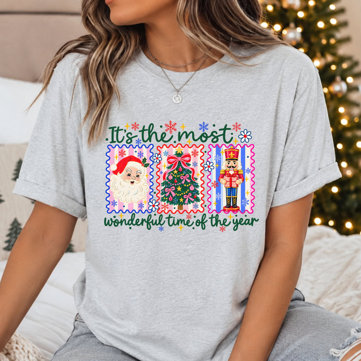 “It’s the most wonderful time of the year” with Santa, a tree with pink bows and a nutcracker in three colorful striped stamp frames, surrounded by daisies and snowflakes.