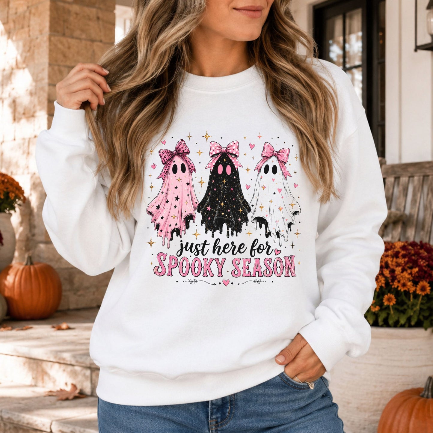Just Here for Spooky Season Halloween DTF transfer featuring three dripping sheet ghosts in pink, black and white with oversized coquette bows, sparkling stars and tiny hearts, paired with pink vintage lettering on a white sweatshirt mockup.