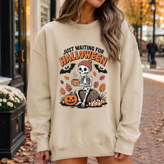 Just Waiting For Halloween DTF transfer featuring a skeleton in a beanie holding hot coffee with bats, pumpkin, candy corn and colorful fall leaves