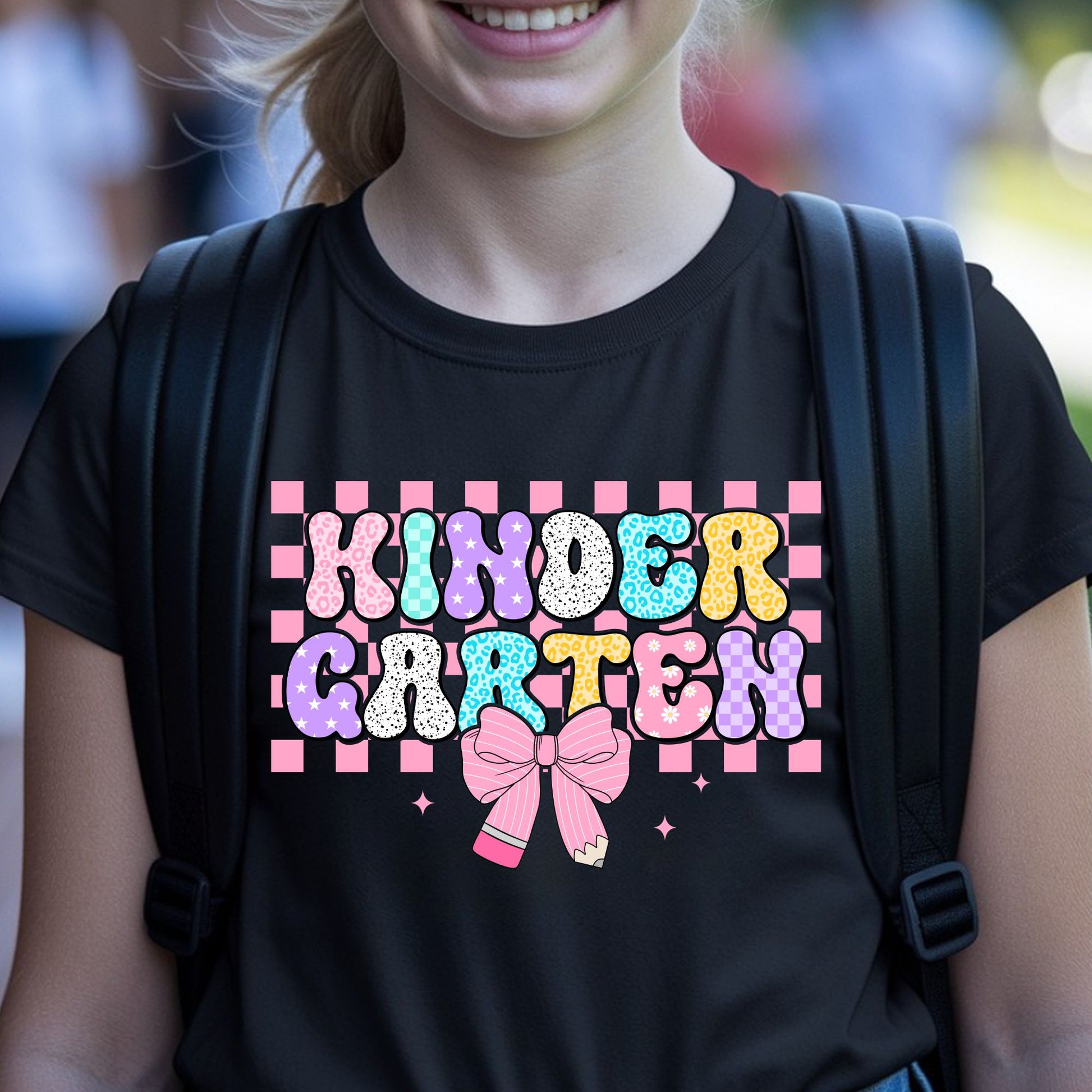 Kindergarten back-to-school design featuring colorful patterned bubble letters, a pink checkerboard background, pencil bow, sparkles, leopard print, stars, and playful classroom details.