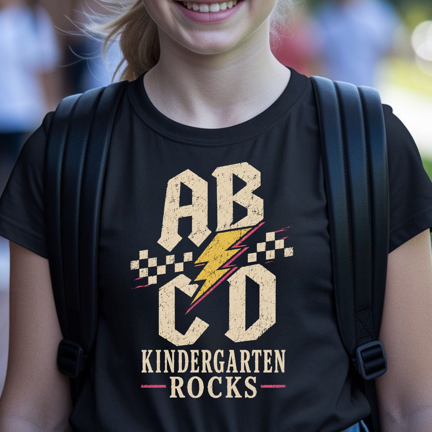 Kindergarten Rocks back-to-school design with bold ABCD letters, a lightning bolt, checker accents, and a distressed retro style for kids shirts.