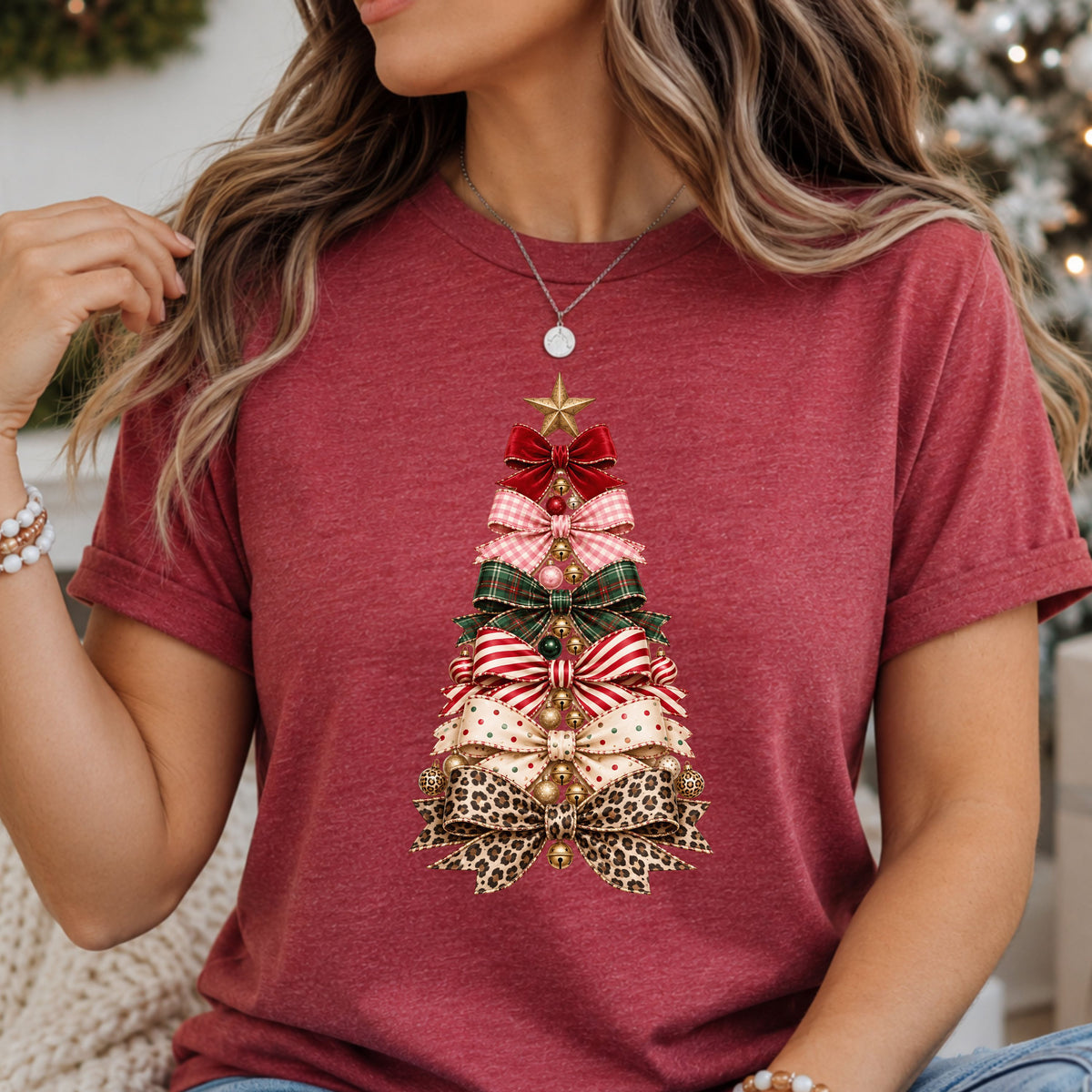 Christmas tree formed from red, pink gingham, green plaid, candy cane striped, cream polka dot and leopard print bows, decorated with gold jingle bells, ornaments and a gold star.