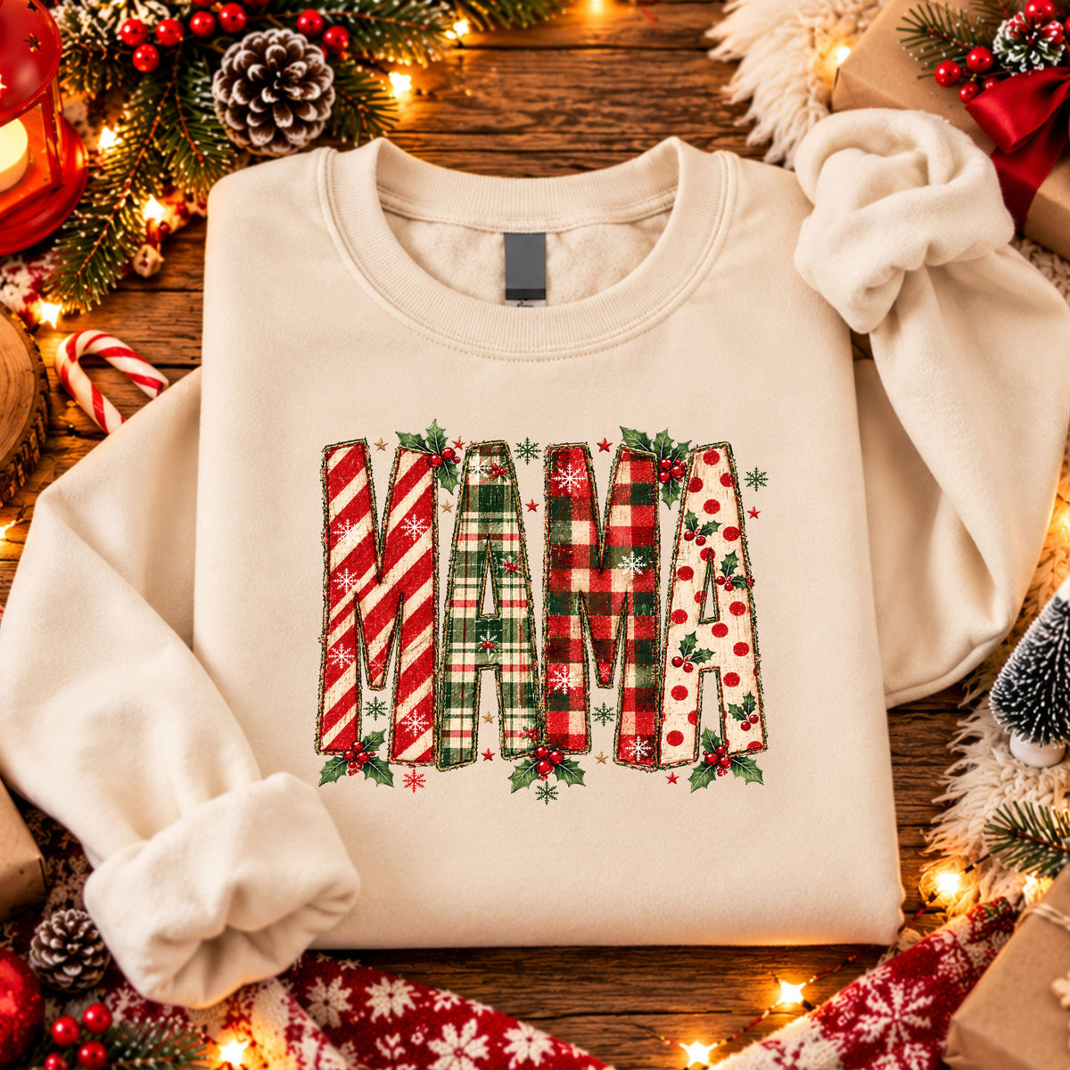 “MAMA” in tall faux patchwork letters featuring candy cane stripes, green plaid, red plaid and red polka dots, accented with holly, snowflakes and stars.