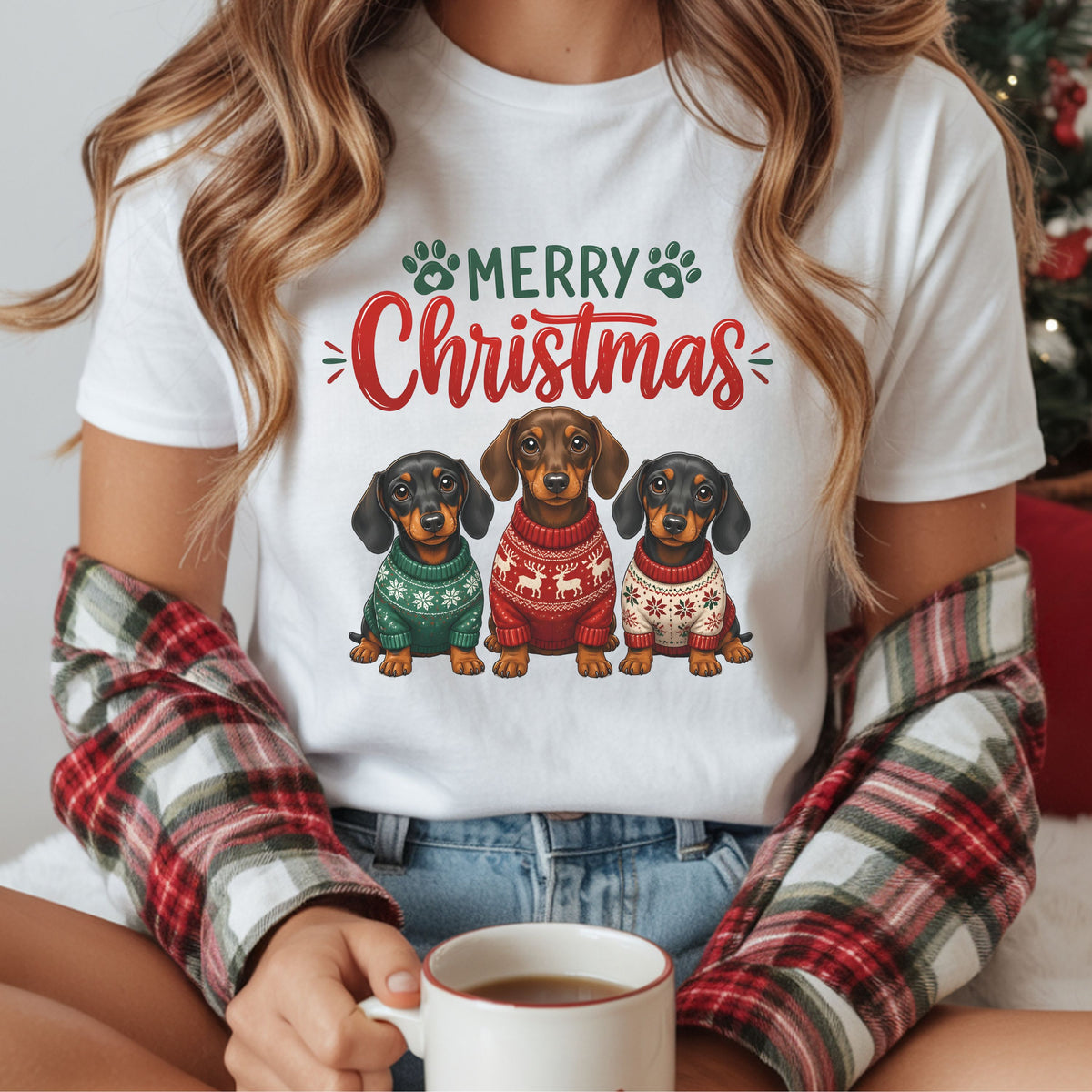 Merry Christmas DTF transfer featuring three dachshunds in green, red and cream holiday sweaters beneath red and green lettering with paw prints.