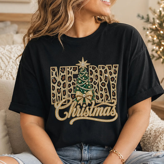 Merry Christmas DTF transfer with gold faux rhinestone script, leopard-print block letters, an emerald green Christmas tree, gold bow and star topper.