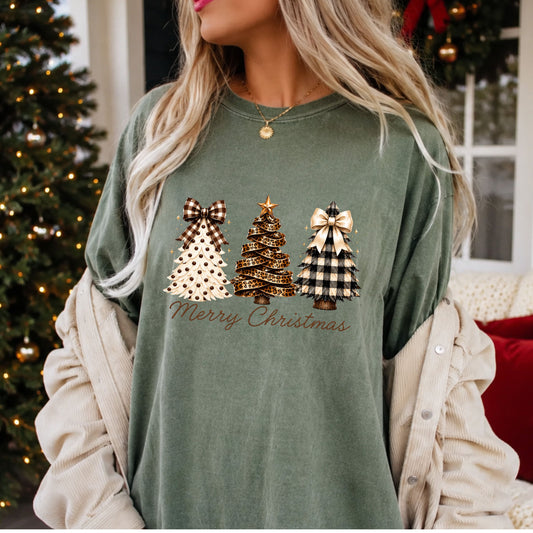 “Merry Christmas” in brown script beneath three trees: cream with brown dots and a gingham bow, leopard ribbon with a gold star, and black and cream plaid with an ivory bow.