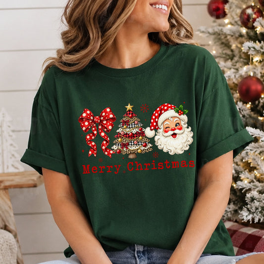 Merry Christmas DTF transfer with red lettering beneath a red polka dot bow, a leopard and plaid Christmas tree, and a winking Santa wearing a red polka dot hat.