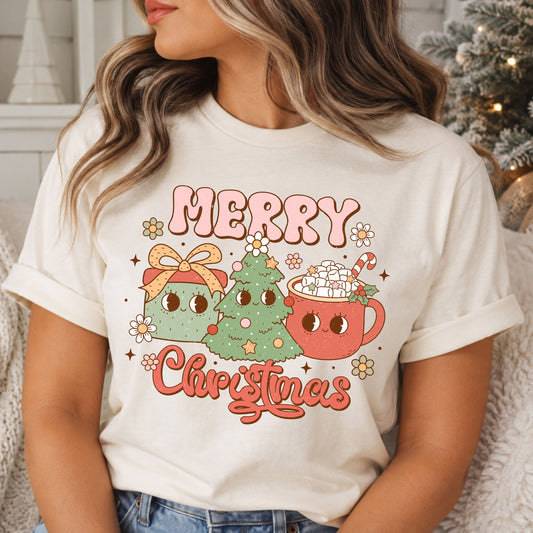 Merry Christmas in pink bubble letters and coral script around a smiling sage green tree, gift with a peach bow and coral hot cocoa mug topped with marshmallows, surrounded by daisies and stars.
