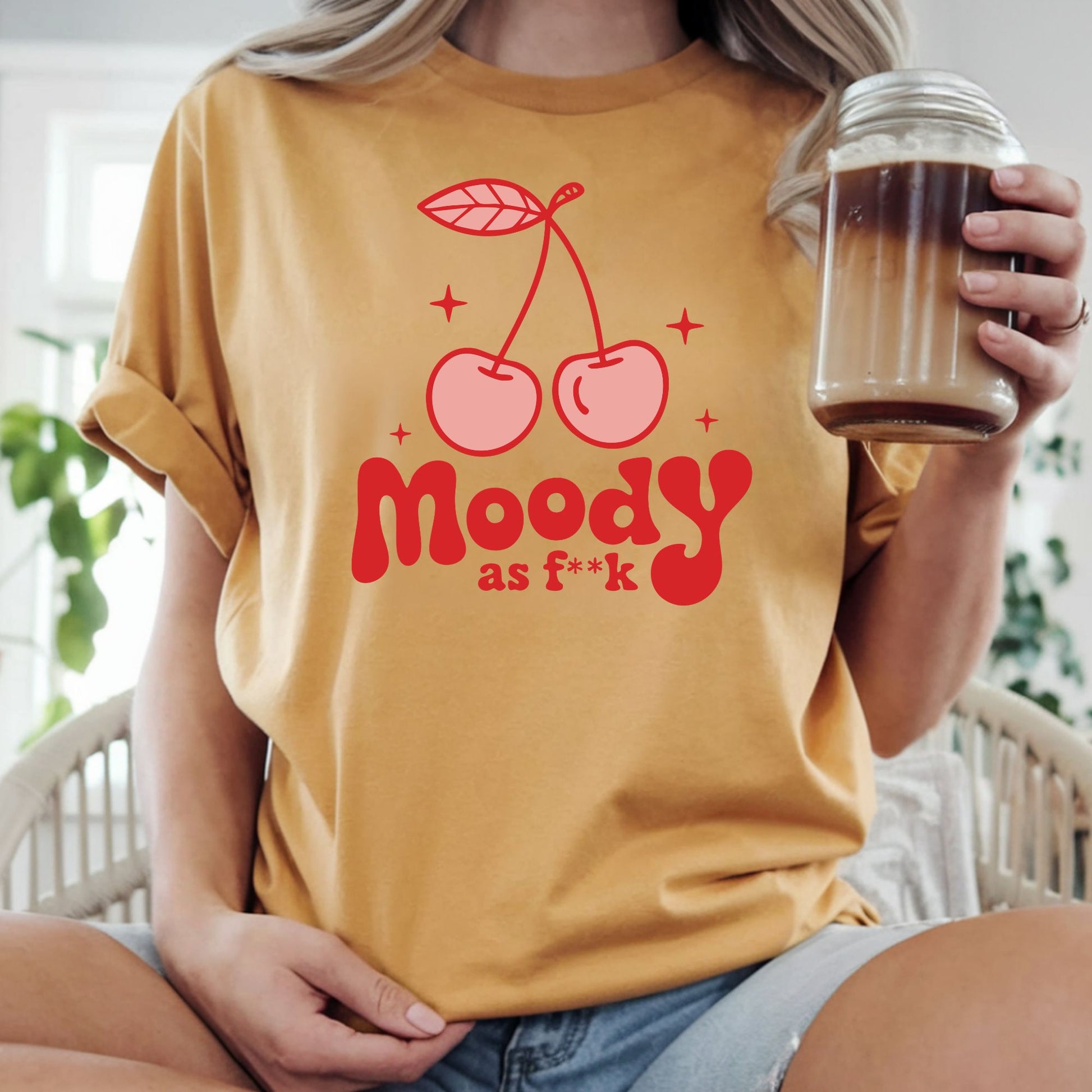 Funny retro cherry graphic featuring the phrase "Moody as F**k" with pink cherries and bold vintage typography. Perfect for sarcastic graphic tees, hoodies, trendy boutique apparel, and statement shirts.
