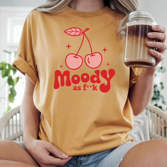 Funny retro cherry graphic featuring the phrase "Moody as F**k" with pink cherries and bold vintage typography. Perfect for sarcastic graphic tees, hoodies, trendy boutique apparel, and statement shirts.
