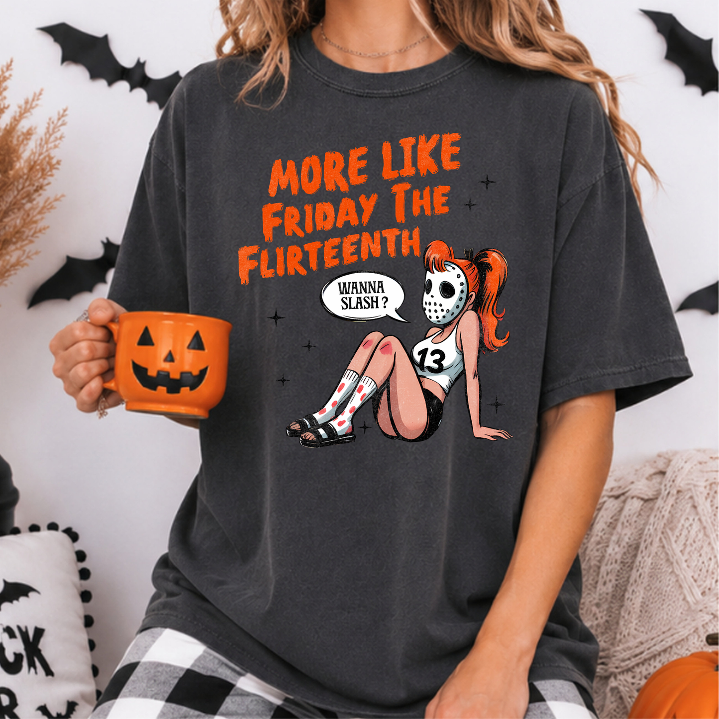 More Like Friday the Flirteenth Halloween DTF transfer featuring a flirty red-haired pinup wearing a hockey mask, number 13 tank top, blood-splattered socks and black shorts with the phrase Wanna Slash on a dark gray T-shirt mockup.