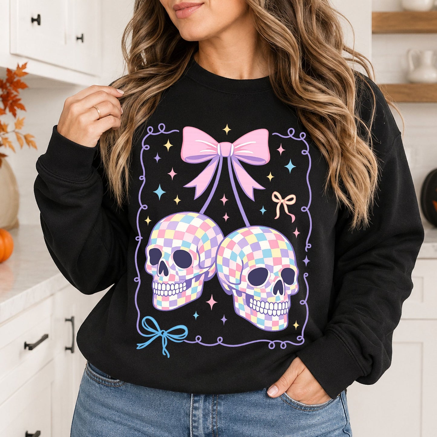 Black sweatshirt mockup featuring two pastel checkered skull cherries, a pink bow, colorful sparkles, and coquette Halloween details.