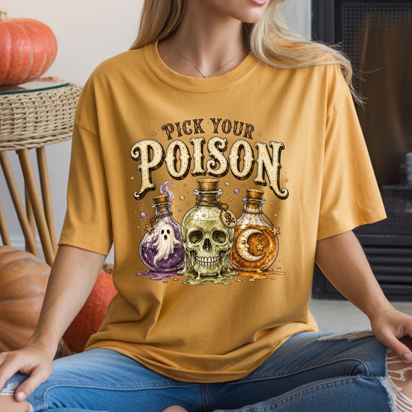 Pick Your Poison Halloween DTF transfer featuring a dripping skull-shaped potion bottle between purple ghost and orange crescent moon potions, surrounded by bubbles, stars and vintage magical accents on a mustard yellow T-shirt mockup.