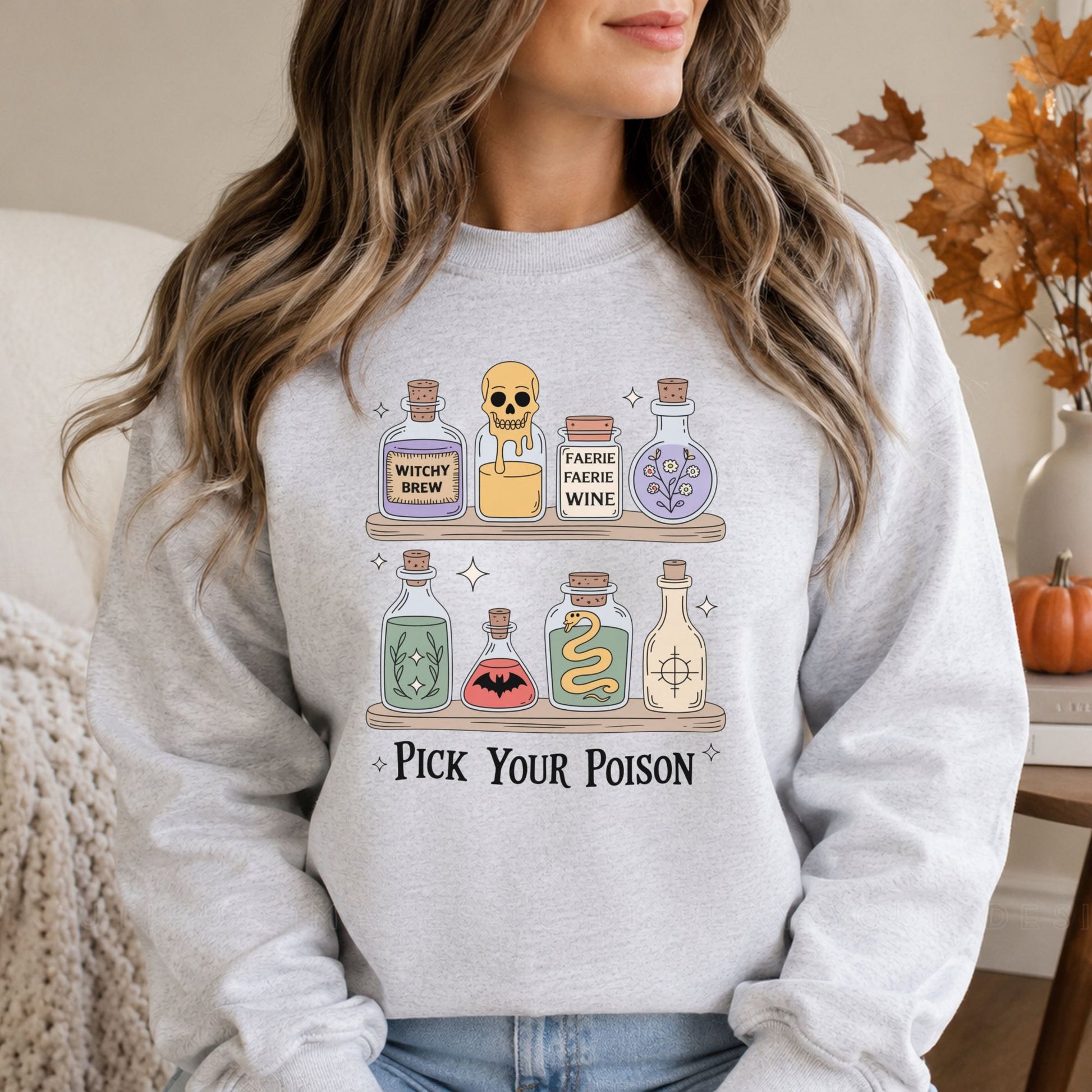 Pick Your Poison Halloween DTF transfer featuring two shelves of colorful witchy potion bottles labeled Witchy Brew and Faerie Wine with a dripping skull, flowers, bat, snake, botanical elements and magical star accents on a gray sweatshirt mockup.