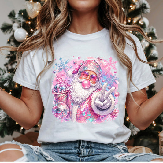 Pink disco Santa Christmas DTF transfer with bubblegum, a peace sign, mirrored pink suit, purple sunglasses and a sack of disco balls surrounded by pastel snowflakes.