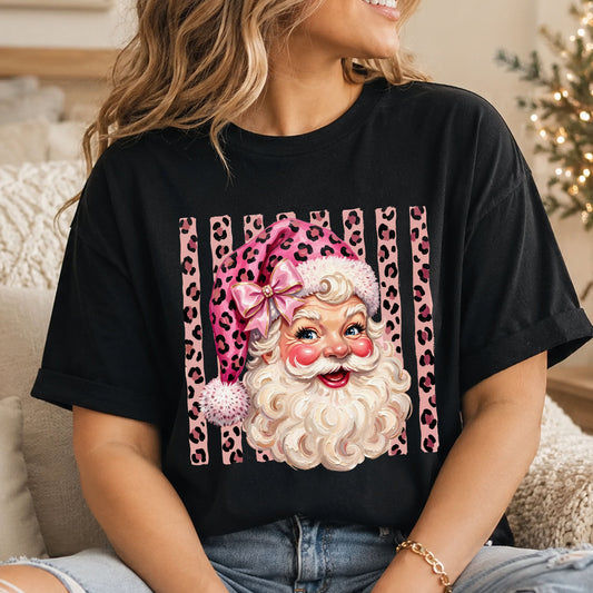 Smiling vintage-style Santa with blue eyes, a pink leopard print hat and gold-trimmed pink bow, set against vertical pink leopard print stripes.
