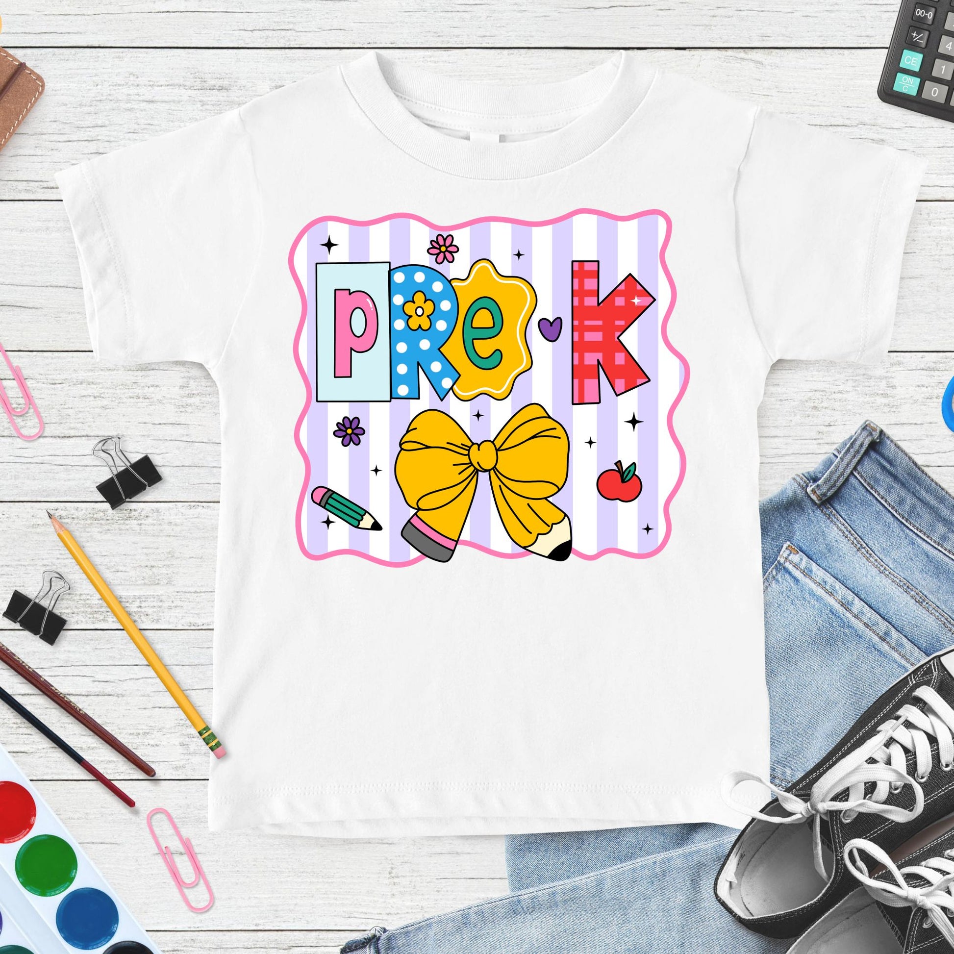 Pre-K back-to-school design featuring colorful patterned letters, a large yellow pencil bow, flowers, apple, pencil accents, sparkles, and pastel striped classroom graphics.