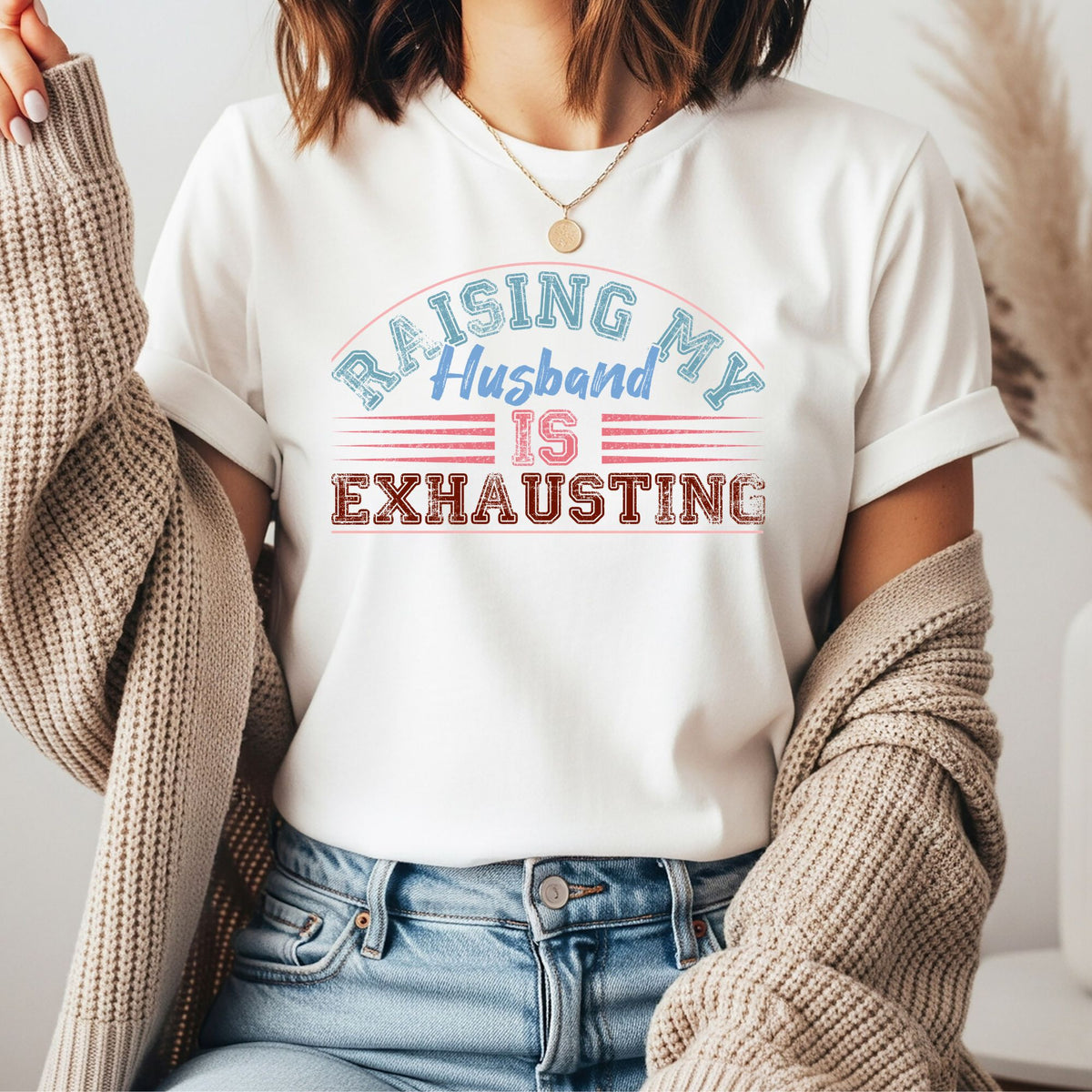 Funny retro graphic featuring the phrase "Raising My Husband Is Exhausting" in distressed vintage lettering. Perfect for wives, moms, married life humor, and sarcastic graphic tees and hoodies.
