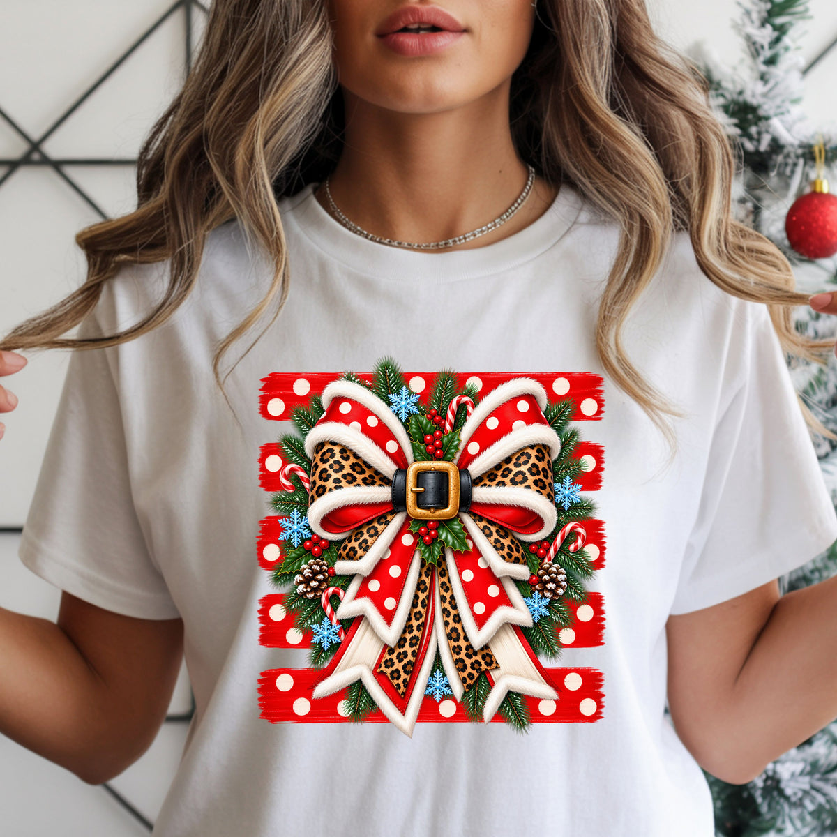 Christmas DTF transfer with a red polka dot and leopard-print bow, white fur-style trim, Santa belt buckle, pine branches, candy canes and blue snowflakes.