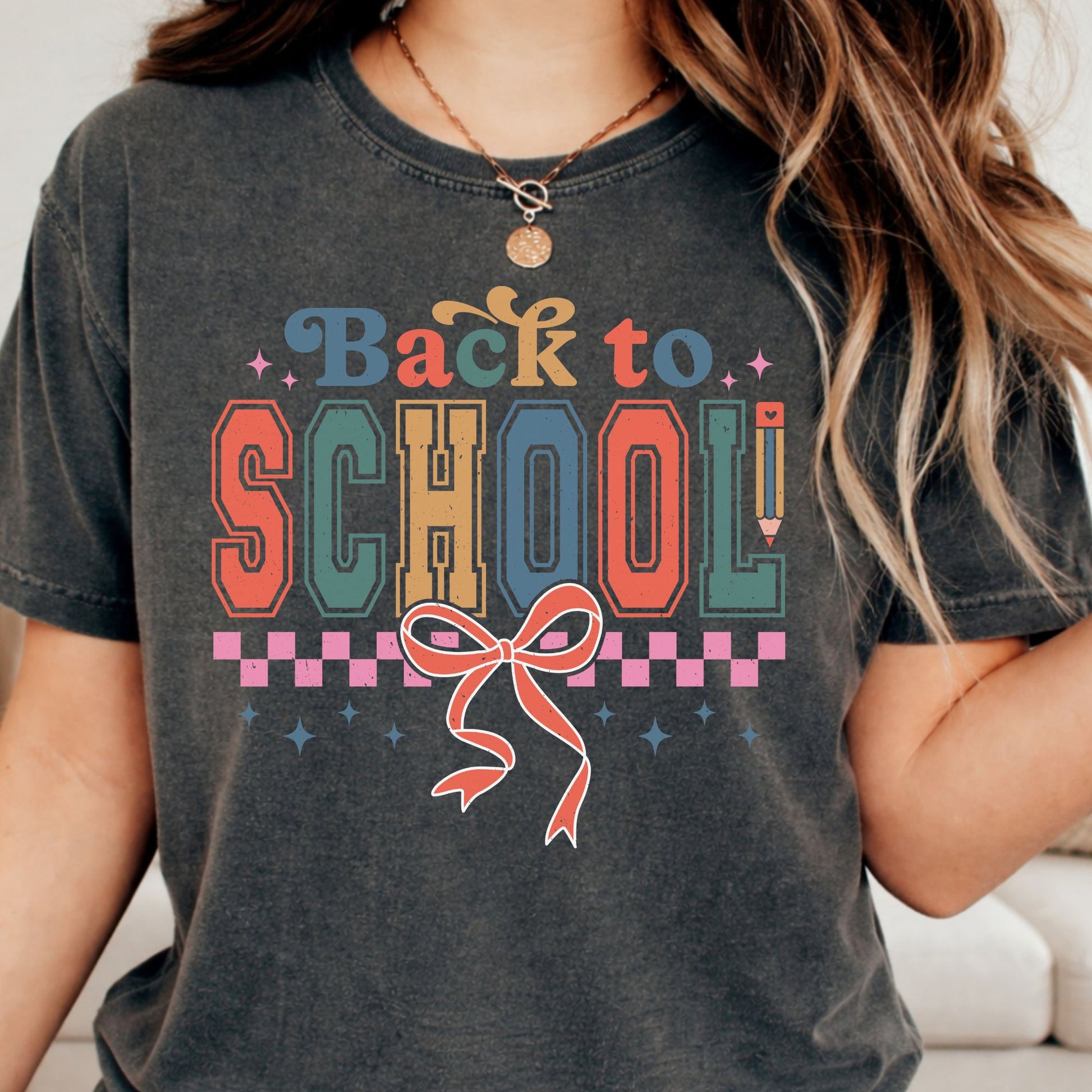 Retro Back to School design featuring distressed varsity-style lettering, a pink checkerboard border, pencil accent, sparkles, and a large coral bow in muted blue, teal, mustard, coral, and pink tones.
