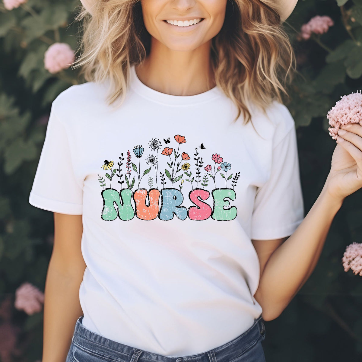 Retro floral nurse DTF transfer featuring colorful groovy lettering with pink, blue, yellow, coral, and green wildflowers for nurse shirts, sweatshirts, and healthcare apparel.