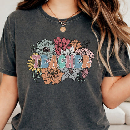 Retro floral Teacher design featuring distressed pastel lettering surrounded by a large bouquet of colorful wildflowers in pink, blue, orange, yellow, and sage green.