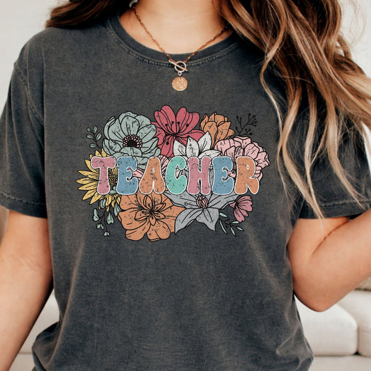 Retro floral Teacher design featuring distressed pastel lettering surrounded by a large bouquet of colorful wildflowers in pink, blue, orange, yellow, and sage green.