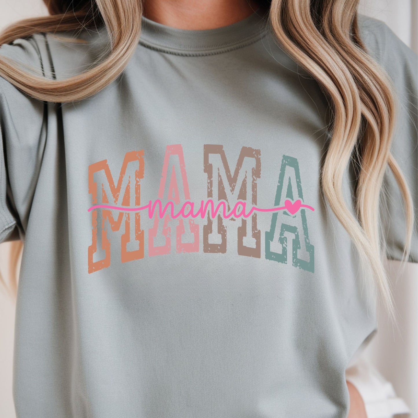 Retro Mama typography featuring distressed multicolor varsity block letters with pink script lettering and heart accent. Perfect for moms, Mother's Day, and everyday boutique apparel.
