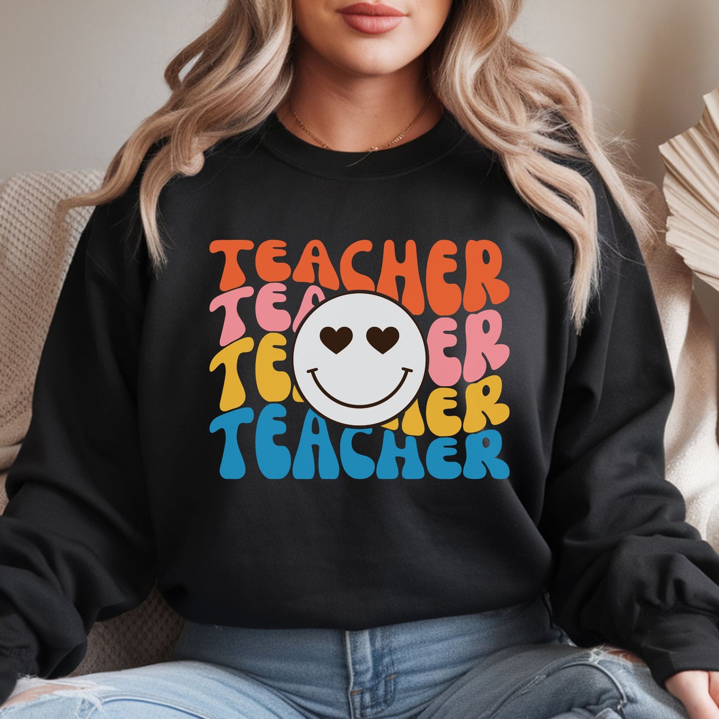Retro teacher design featuring stacked colorful Teacher lettering with a heart eyes smiley face in the center in a playful 70s-inspired aesthetic.