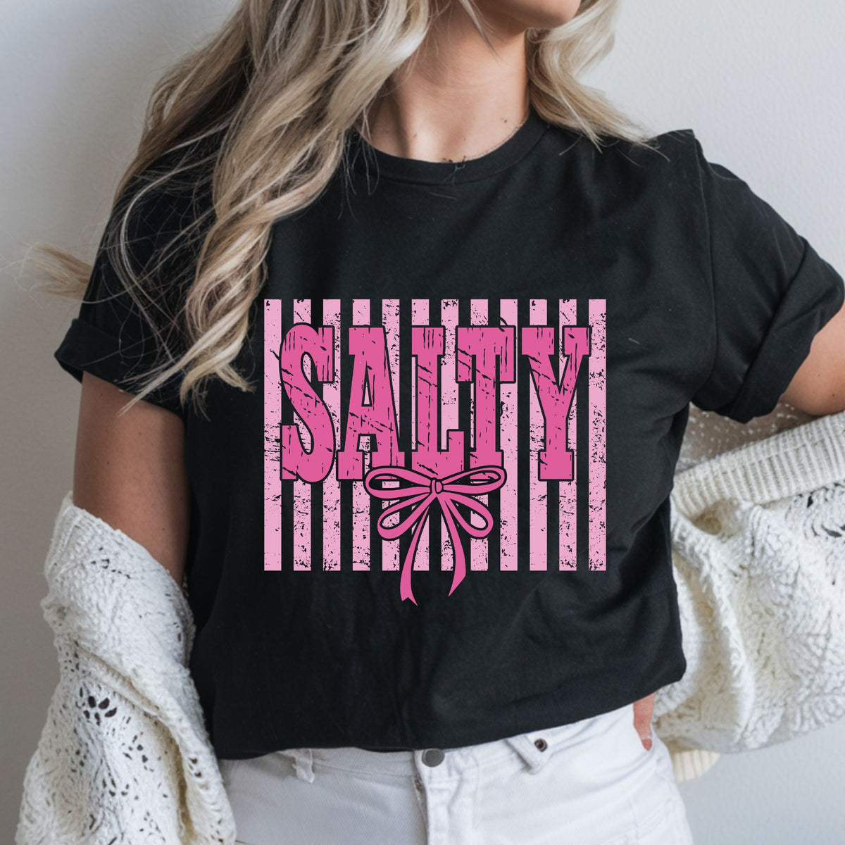 Salty DTF transfer featuring bold distressed pink lettering, a large coquette bow, and a pink striped grunge background for funny women’s shirts, sweatshirts, tote bags, and trendy graphic apparel.
