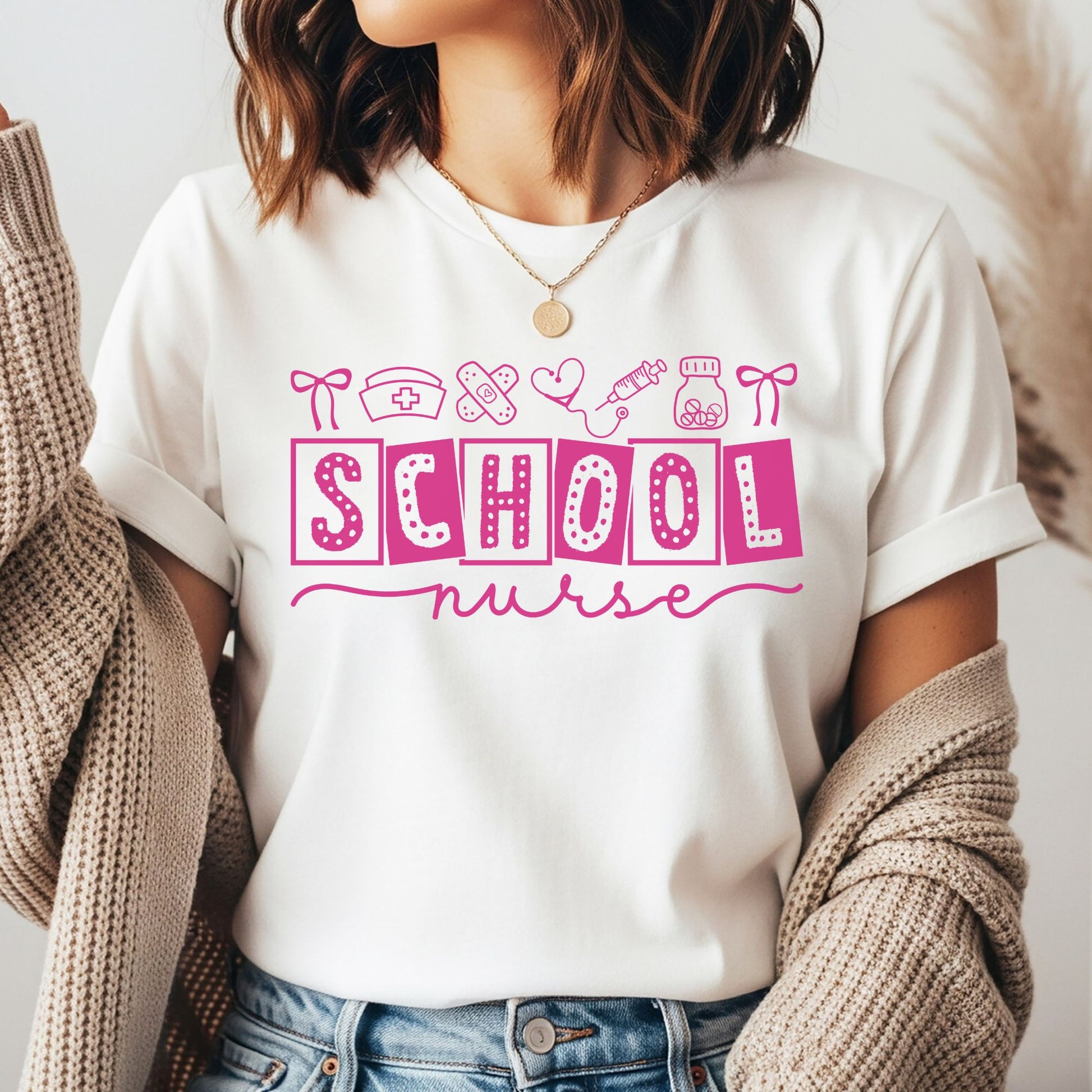 Pink School Nurse design featuring bold patterned lettering with medical doodles including a nurse cap, bandages, heart stethoscope, syringe, medicine bottle, and bows.