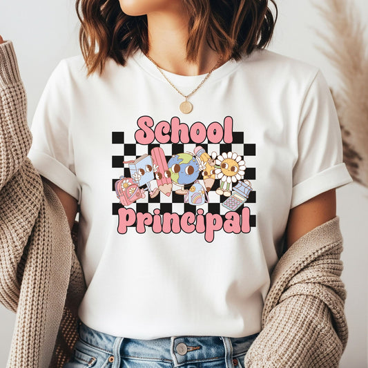School Principal DTF transfer featuring pink lettering, a black checkerboard background, and cute school supply characters including books, pencils, globe, backpacks, and calculator.