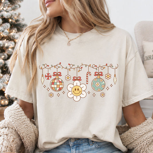 Retro Christmas garland with string lights, a disco ball, smiling daisy, floral ornament, bows, candy cane and peppermint in muted red, sage, yellow and cream.