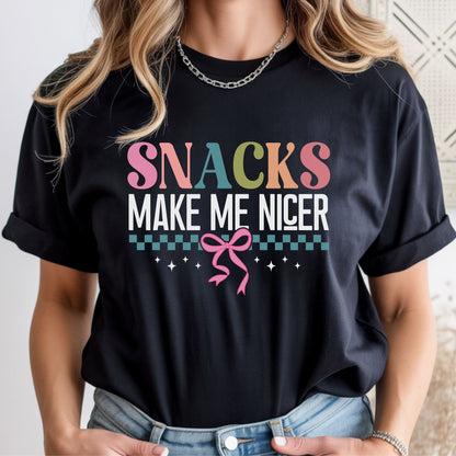 Funny Snacks Make Me Nicer design featuring colorful retro typography, white lettering, teal checkerboard accents, sparkles, and a pink coquette bow. Perfect for food lovers and snack enthusiasts.
