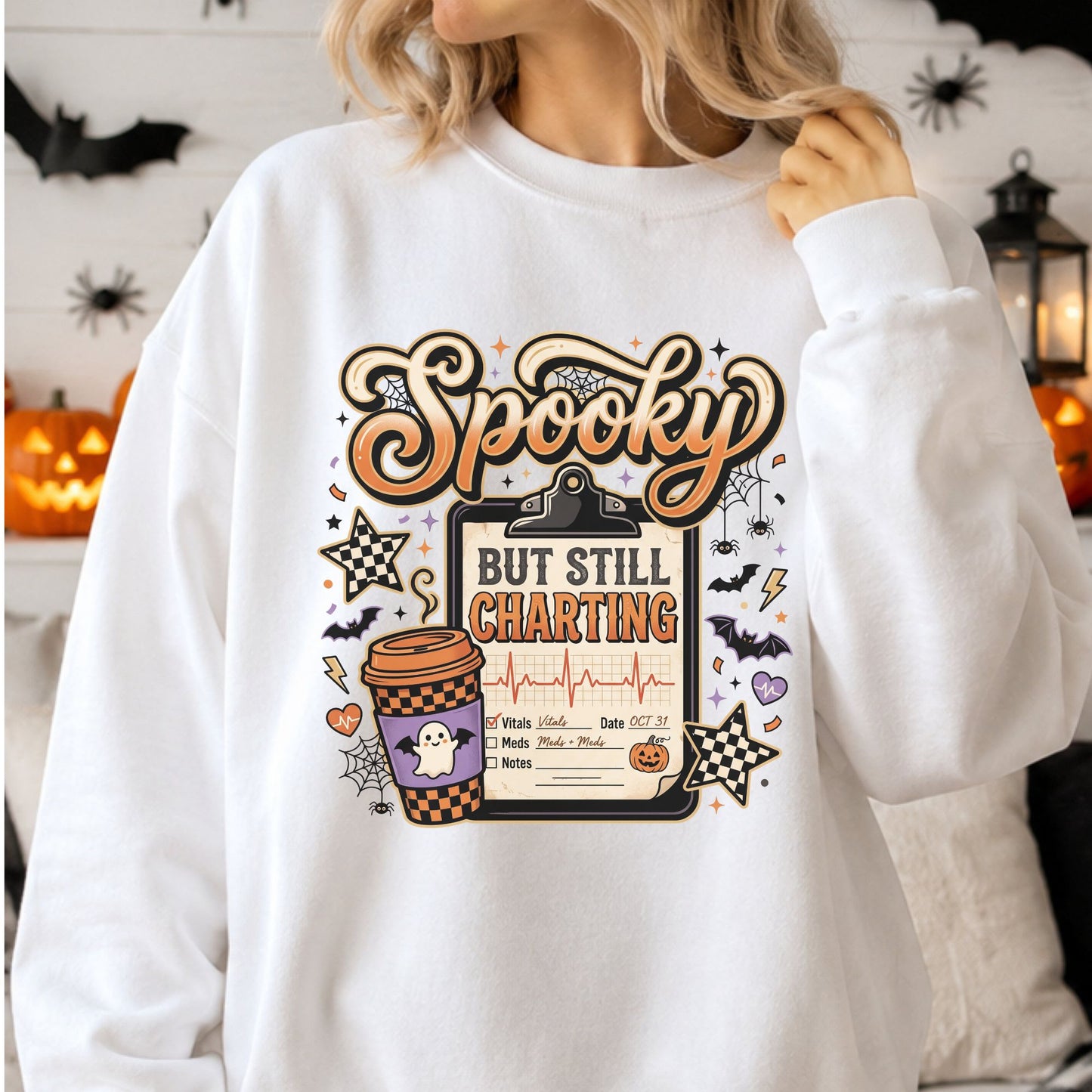 Spooky but Still Charting Halloween nurse DTF transfer featuring a medical clipboard with patient chart, heartbeat line and October 31 date, plus a ghost coffee cup, bats, spiders, spiderwebs, pumpkins, checkerboard stars and orange and purple accents on a white sweatshirt mockup.