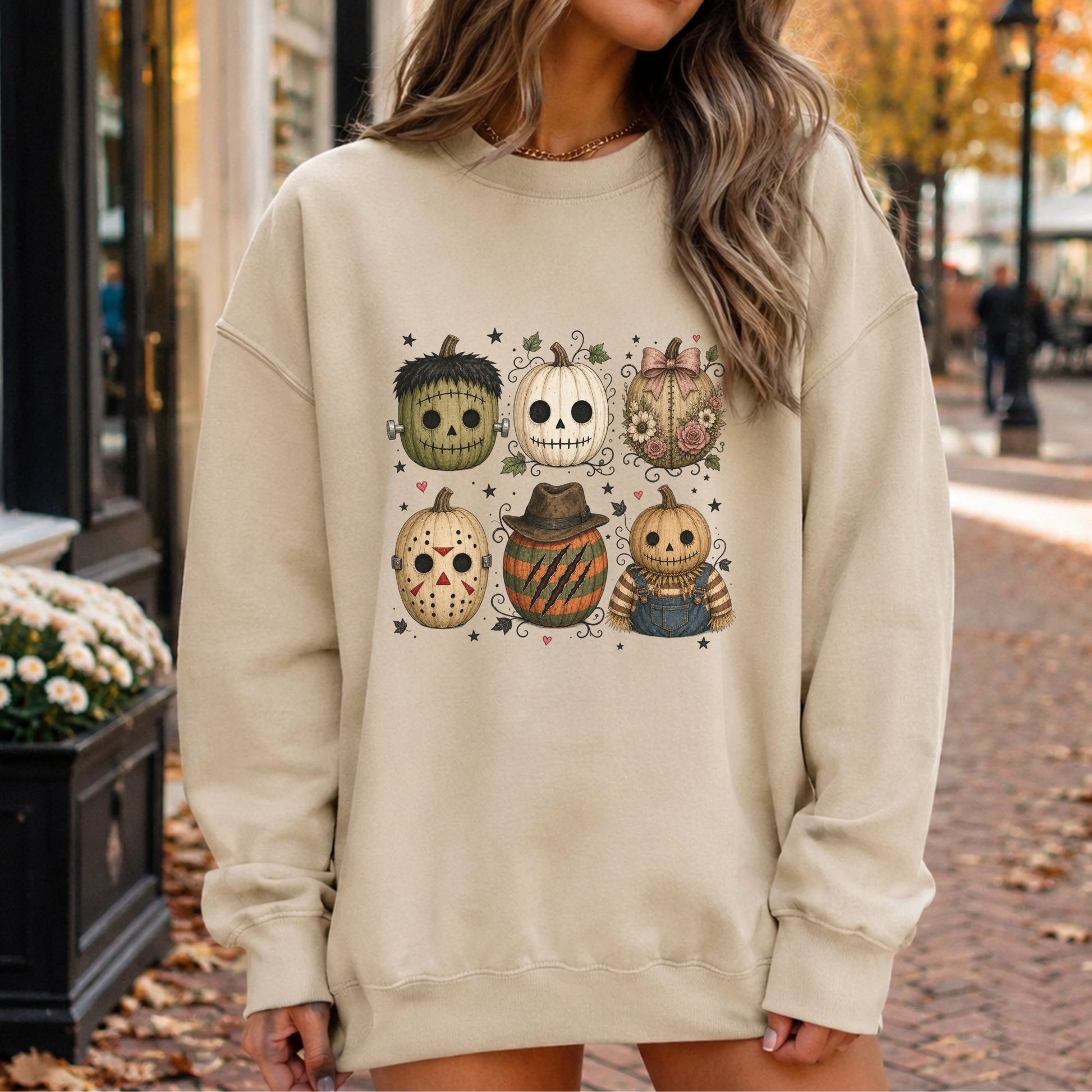 Spooky Halloween DTF transfer featuring six vintage-style character pumpkins inspired by classic monsters, skeletons, masked villains and scarecrows, with stitched details, flowers, stars, vines and tiny hearts on a cream sweatshirt mockup.