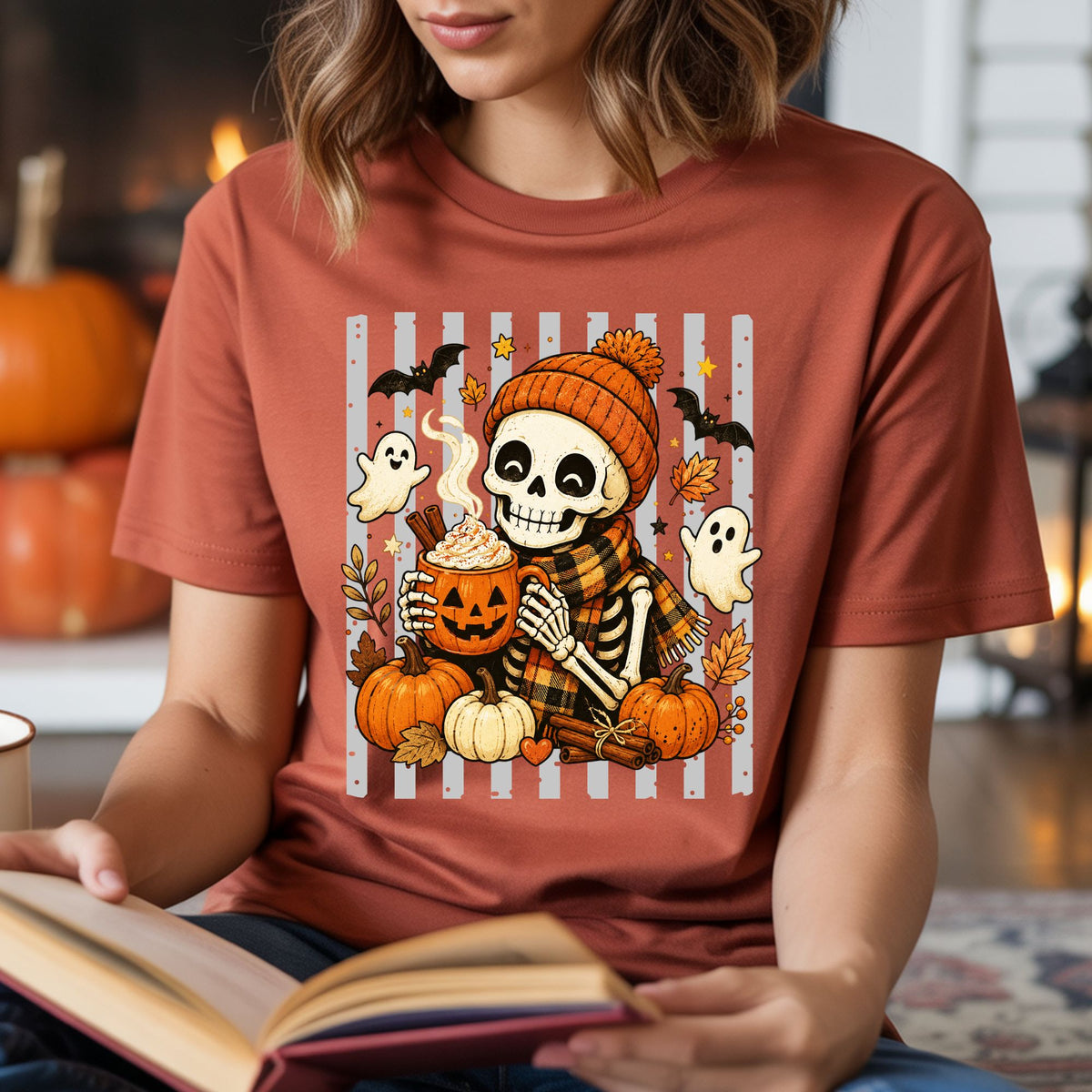 Spooky Halloween DTF transfer featuring a smiling skeleton in an orange beanie and plaid scarf holding pumpkin spice coffee with ghosts, pumpkins, bats and fall leaves