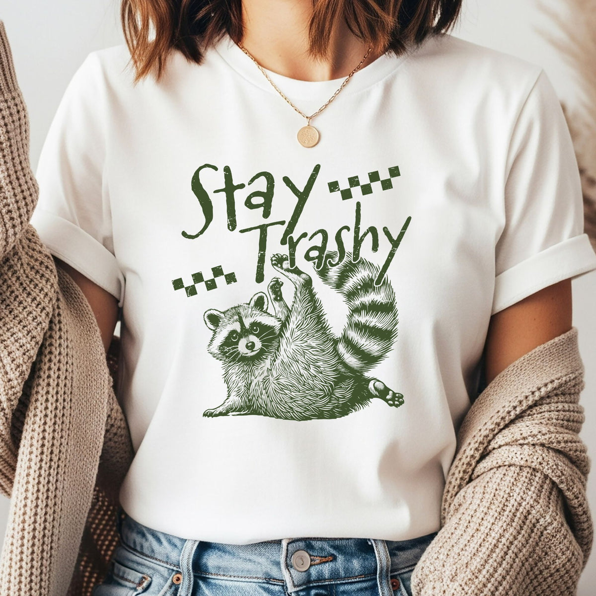 Stay Trashy green raccoon DTF transfer featuring two vintage-style raccoons in a distressed green design with checkerboard accents, perfect for funny raccoon shirts, trash panda sweatshirts, tote bags, and quirky animal apparel.