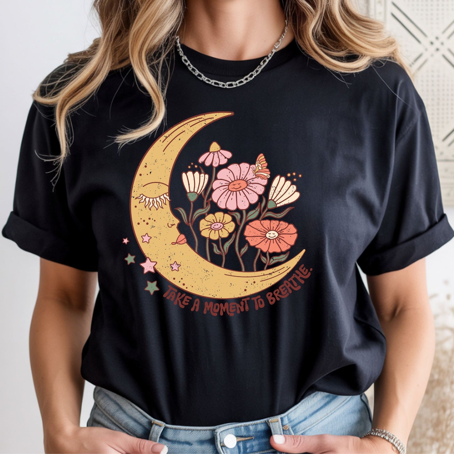 Boho crescent moon with whimsical flowers, stars, and butterfly featuring the inspirational quote "Take a Moment to Breathe." Perfect for boho, mindfulness, cottagecore, and nature-inspired apparel.
