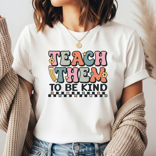 Teach Them to Be Kind DTF transfer featuring retro multicolor lettering, a pencil, flowers, stars, hearts, and a black checkerboard accent.