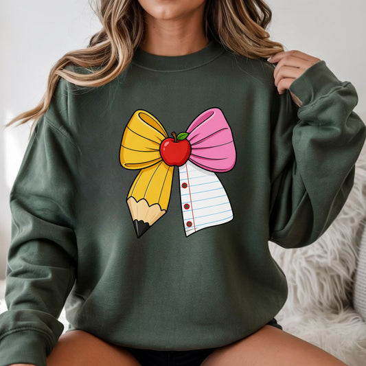 Teacher coquette pencil bow DTF transfer featuring a large yellow pencil and pink notebook-paper bow with a red apple center, perfect for teacher shirts, back to school sweatshirts, tote bags, and classroom apparel.