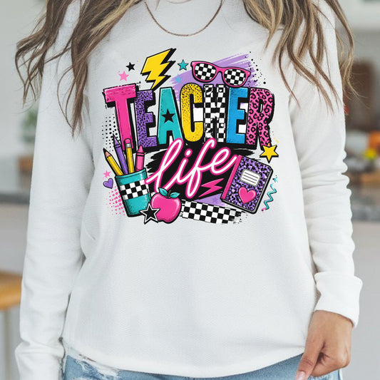 Teacher Life design featuring bold colorful lettering with checkerboard and leopard print patterns, sunglasses, lightning bolt, pencils, notebook, apple, stars, hearts, and bright retro school supplies.