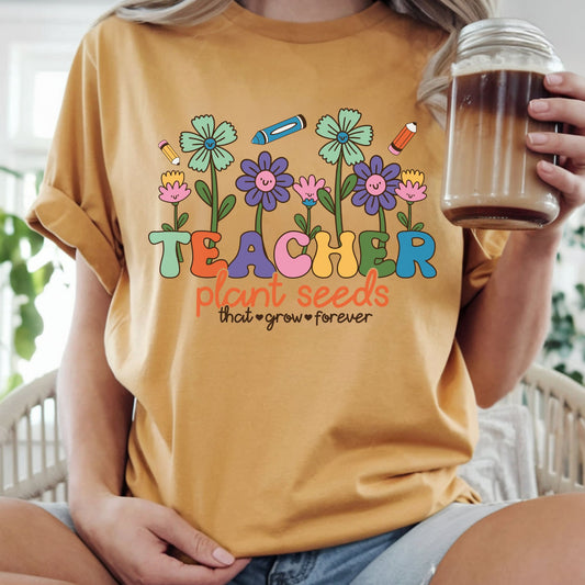 Teacher Plant Seeds That Grow Forever DTF transfer featuring colorful smiling flowers, pencils, crayons, and cheerful retro classroom lettering.