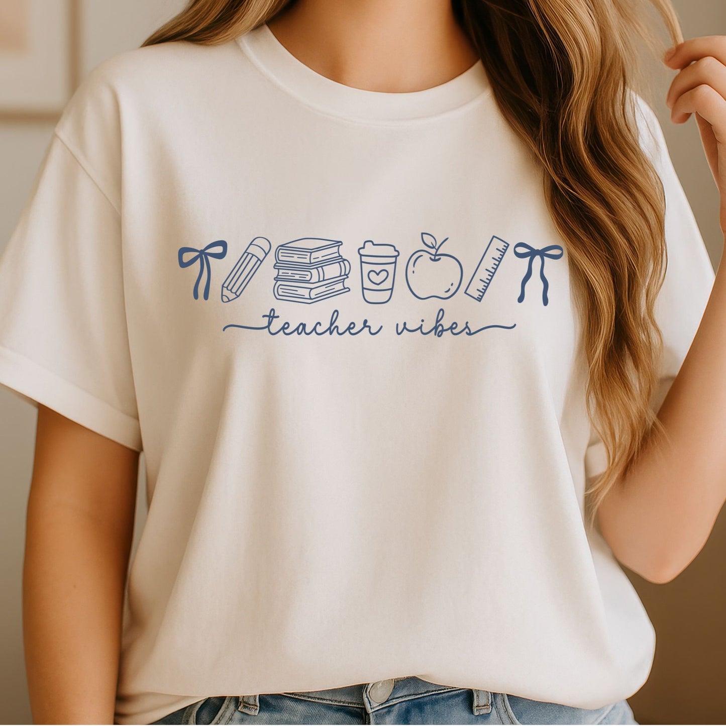 Blue Teacher Vibes design featuring bows, pencil, stacked books, coffee cup, apple, ruler, and clean school doodle line art for teacher shirts and classroom apparel.