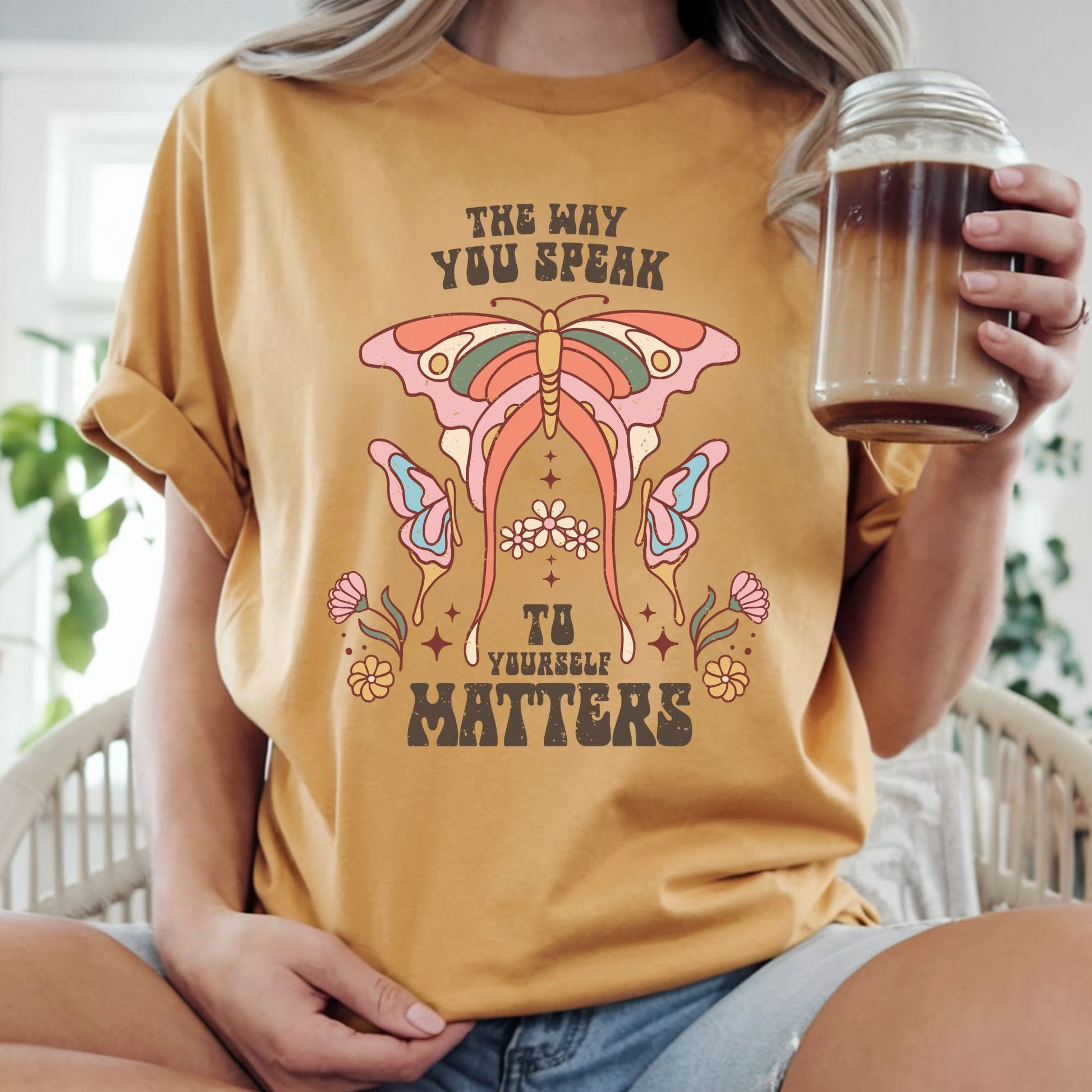 Boho butterfly graphic with pastel flowers and the inspirational quote "The Way You Speak to Yourself Matters." Retro mental health, self-love, and positive affirmation design for graphic tees and hoodies.

