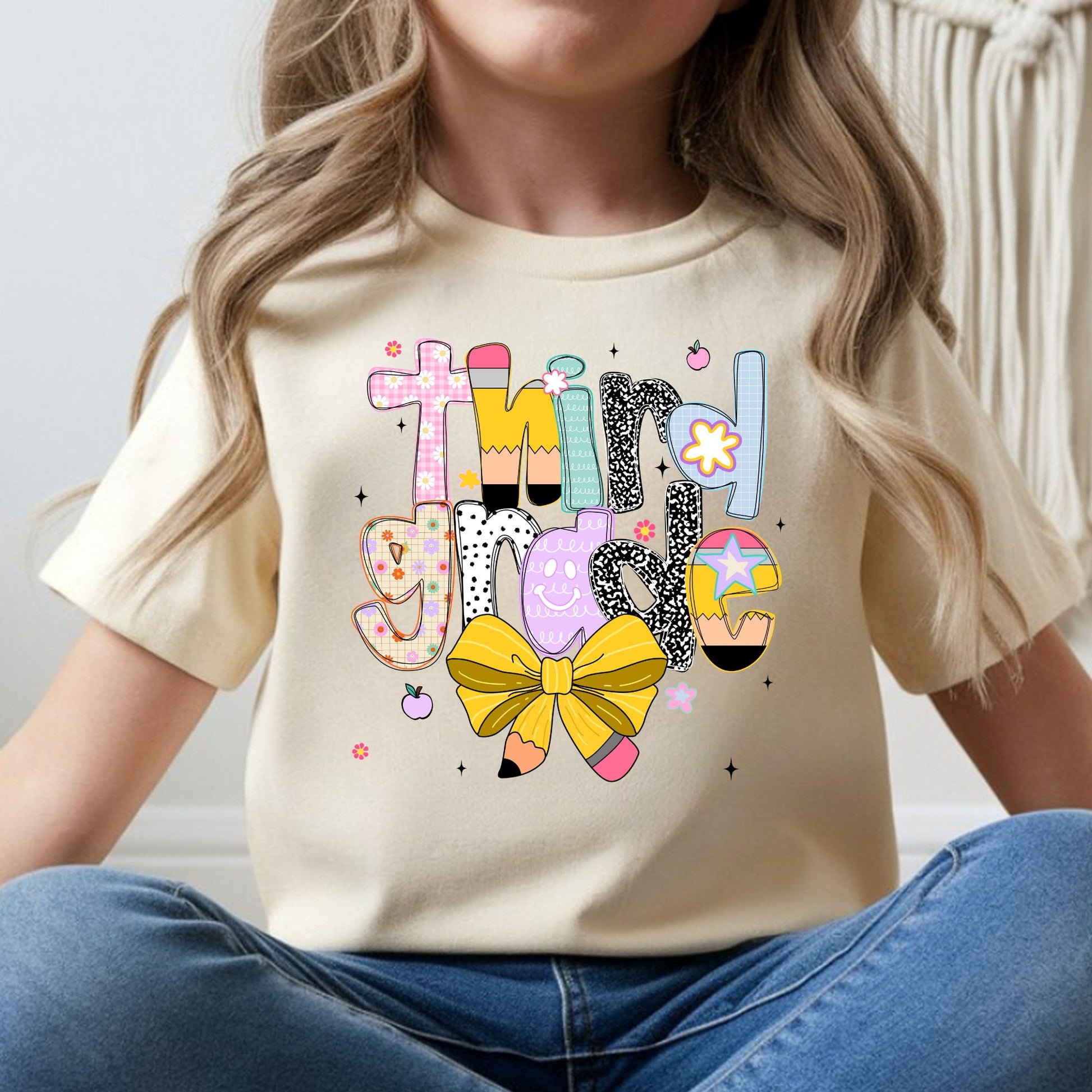 Third Grade back-to-school design featuring colorful patterned letters, pencil accents, a yellow pencil bow, flowers, apples, and playful classroom details for kids shirts.